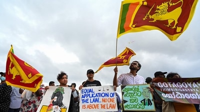 Demonstrators hols placards and Sri Lankan flags during a protest against the Sri Lankan government and for the release of student leaders in Colombo on September 9, 2022. (AFP) Demonstrators hols placards and Sri Lankan flags during a protest against the Sri Lankan government and for the release of student leaders in Colombo on September 9, 2022. (AFP)