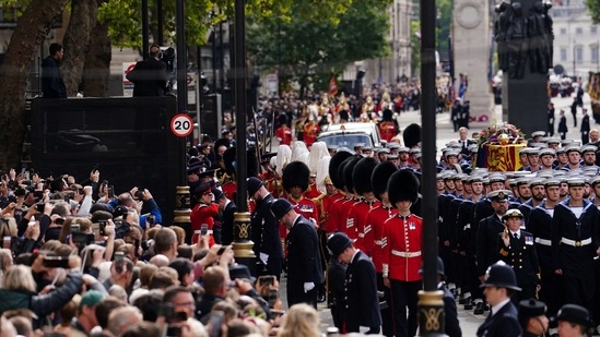 Queen Elizabeth II's Funeral: Crowds watch as the State Gun Carriage carries the coffin of Queen Elizabeth II.(Reuters)