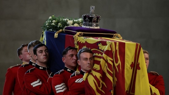 The Queen's coffin was topped by a wreath of white roses and her crown resting on a purple velvet pillow.(REUTERS)