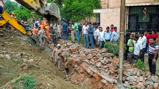 Noida: Rescue operations after a portion of a boundary wall of a housing society collapsed, at Jal Vayu Vihar in Noida, Tuesday, (PTI Photo)