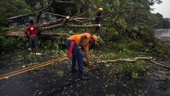 Footage from local media showed residents of the east coast town of Higuey waist-deep in water, trying to salvage personal belongings.(AFP)