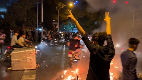 Iran Protests: A demonstrator raises his arms and makes the victory sign during a protest in Tehran.(AFP)