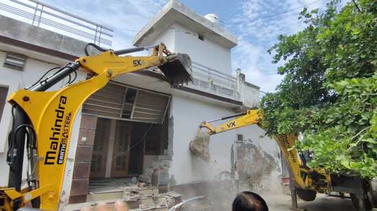 The house belonging to the suspected drug peddler being razed in Ambala Cantonment. (HT Photo)
