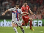 Barcelona's Robert Lewandowski, left, challenges for the ball with Bayern's Marcel Sabitzer (AP) Barcelona's Robert Lewandowski, left, challenges for the ball with Bayern's Marcel Sabitzer (AP)