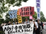 Shinzo Abe's State Funeral: Demonstrators hold placards during a protest against the planned state funeral for former Prime Minister Shinzo Abe in Tokyo, Japan.(Bloomberg) Shinzo Abe's State Funeral: Demonstrators hold placards during a protest against the planned state funeral for former Prime Minister Shinzo Abe in Tokyo, Japan.(Bloomberg)
