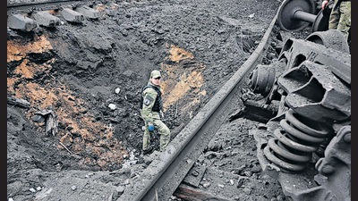 A forensic explosives expert examines a crater from a missile explosion in Kharkiv. (AFP) A forensic explosives expert examines a crater from a missile explosion in Kharkiv. (AFP)