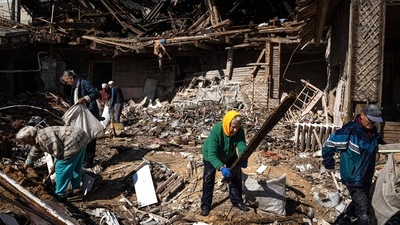 Russia-Ukraine War: Local residents collect wood for heating from a destroyed school where Russian forces were based, in the recently retaken area of Izium, Ukraine. (AP)