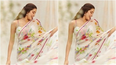 Janhvi draped a white chiffon saree with translucent details. The saree also featured minimal floral patterns in multicoloured shades. It also came with a pink border. (Instagram/@janhvikapoor)