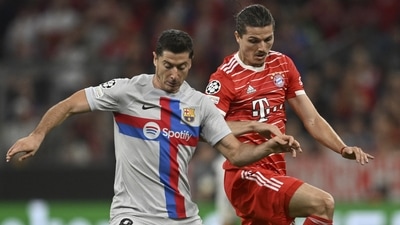 Barcelona's Robert Lewandowski, left, challenges for the ball with Bayern's Marcel Sabitzer (AP) Barcelona's Robert Lewandowski, left, challenges for the ball with Bayern's Marcel Sabitzer (AP)