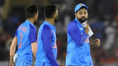 India's captain Rohit Sharma, right, and teammates walk off the field after their loss in the first T20 cricket match against Australia, in Mohali, India, Tuesday, Sept. 20, 2022. (AP Photo/Manish Swarup) (AP) India's captain Rohit Sharma, right, and teammates walk off the field after their loss in the first T20 cricket match against Australia, in Mohali, India, Tuesday, Sept. 20, 2022. (AP Photo/Manish Swarup) (AP)