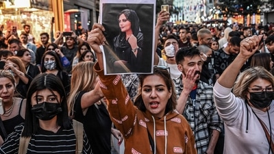 Iran Protests: A protester holds a portrait of Mahsa Amini during a demonstration in support of Mahsa Amini. (AFP) Iran Protests: A protester holds a portrait of Mahsa Amini during a demonstration in support of Mahsa Amini. (AFP)