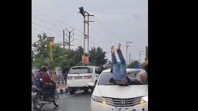 The video purportedly shows several students fleeing even as a speeding Honda City car comes at them head on. The car hits one of the students and he was thrown several feet into the air before collapsing on the road. (Video grab/HT Photo) The video purportedly shows several students fleeing even as a speeding Honda City car comes at them head on. The car hits one of the students and he was thrown several feet into the air before collapsing on the road. (Video grab/HT Photo)