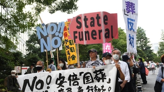 Shinzo Abe's State Funeral: Demonstrators hold placards during a protest against the planned state funeral for former Prime Minister Shinzo Abe in Tokyo, Japan.(Bloomberg)