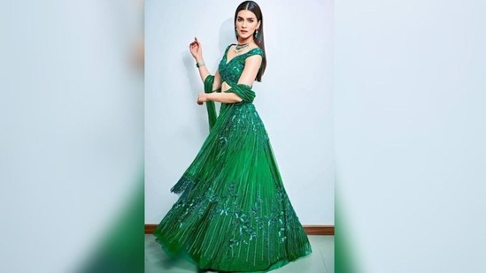 Eighth day of Navratri celebrates the colour peacock green. Get ready in outfit like Kriti Sanon's emerald peacock green lehenga. The dress with intricate tone-on-tone bead and sequin work, an A-line design, and 3D floral embellishments on her voluminous skirt makes her look absolutely stunning. Her off-shoulder blouse’s plunging neckline and the beaded tassels on her dupatta makes a modern case for ethnic looks.(Instagram/@KritiSanon)