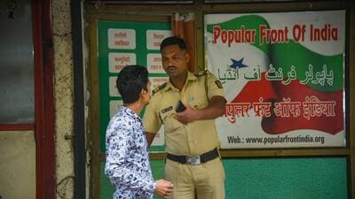 A security person outside a Popular Front of India (PFI) office in Navi Mumbai. (PTI) A security person outside a Popular Front of India (PFI) office in Navi Mumbai. (PTI)
