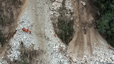 China Earthquake: Rescuers transfer an earthquake affected villager through a damaged mountain road. (AP) China Earthquake: Rescuers transfer an earthquake affected villager through a damaged mountain road. (AP)
