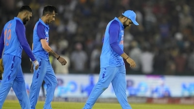 India's captain Rohit Sharma, right, and teammates walk off the field after their loss in the first T20 cricket match against Australia, in Mohali (AP)