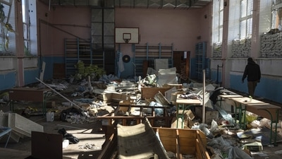 Russia-Ukraine War: A man walks through the sports gym in the school which was used as a Russian military hospital in the recently retaken area of Izium, Ukraine. (AP) Russia-Ukraine War: A man walks through the sports gym in the school which was used as a Russian military hospital in the recently retaken area of Izium, Ukraine. (AP)