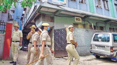 Security personnel keep vigil outside the PFI office in Bengaluru on Thursday during the NIA raids. (PTI)