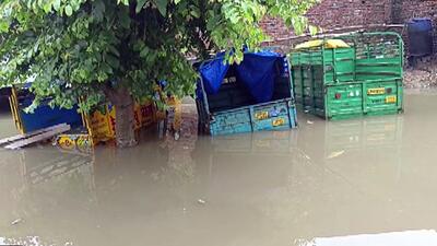 Partially submerged vehicles in a locality in Firozabad. (ANI)