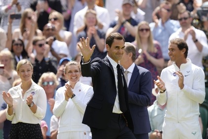 Former Wimbledon singles champion Roger Federer is applauded as he arrives to take part in a 100 years of Centre Court celebration on day seven of the Wimbledon tennis championships in London (AP) Former Wimbledon singles champion Roger Federer is applauded as he arrives to take part in a 100 years of Centre Court celebration on day seven of the Wimbledon tennis championships in London (AP)