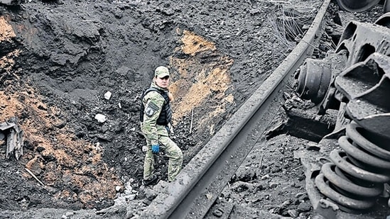 Russia-Ukraine War: A forensic explosives expert examines a crater from a missile explosion in Kharkiv. Russia-Ukraine War: A forensic explosives expert examines a crater from a missile explosion in Kharkiv. 