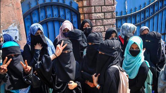 Students outside a college after being denied entry for wearing hijabs, in Karnataka’s Chikmagalur on February 21. (PTI)