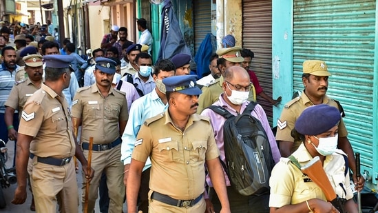 Officers of National Investigation Agency (NIA) with police personnel during a raid at the residence of a functionary of Popular Front of India (PFI), in Madurai.(PTI)