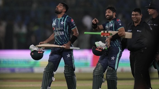Pakistan's captain Babar Azam, left, and batting partner Mohammad Rizwan leave the field after their win in the second T20 cricket match against England(AP)