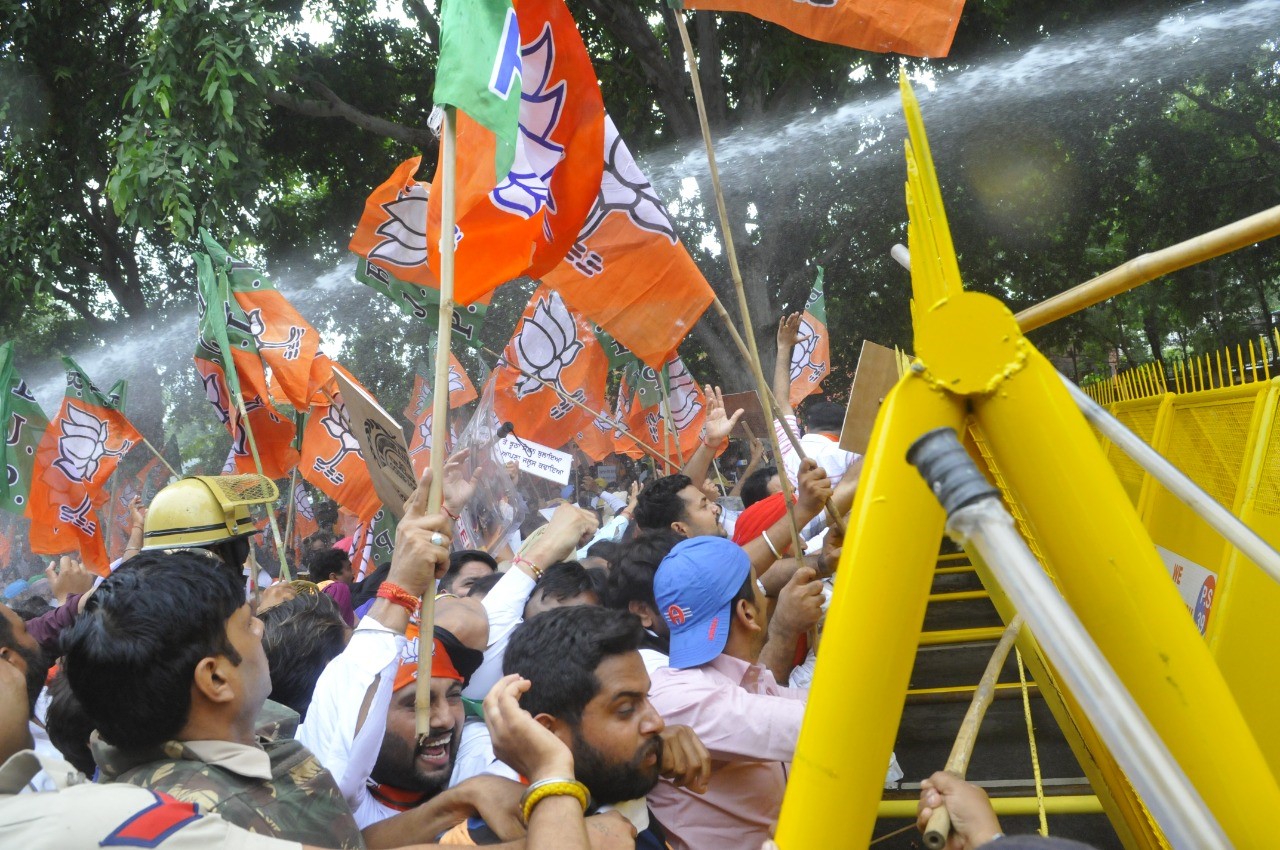 Punjab BJP workers facing water cannons when they tried crossing barricades en route to chief minister Bhagwant Mann’s residence in Chandigarh on Thursday. (Keshav Singh/HT) Punjab BJP workers facing water cannons when they tried crossing barricades en route to chief minister Bhagwant Mann’s residence in Chandigarh on Thursday. (Keshav Singh/HT)
