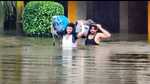 People wading through waist-deep water in Aligarh on Friday. (HT) People wading through waist-deep water in Aligarh on Friday. (HT)