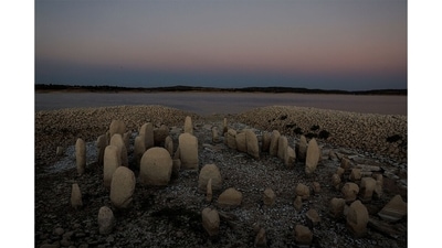 As droughts drop Spain’s Valdecañas reservoir to less than 30% of its capacity, an ancient funerary mound is now visible. Some 144 megalithic stones from 5000 BCE, arranged like a sort of Stonehenge, are being studied at close range. (Susana Vera/REUTERS) As droughts drop Spain’s Valdecañas reservoir to less than 30% of its capacity, an ancient funerary mound is now visible. Some 144 megalithic stones from 5000 BCE, arranged like a sort of Stonehenge, are being studied at close range. (Susana Vera/REUTERS)
