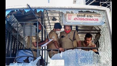 Police personnel take stock of the damages done to a KSRTC bus after some miscreants threw stones during a PFI shutdown (PTI) Police personnel take stock of the damages done to a KSRTC bus after some miscreants threw stones during a PFI shutdown (PTI)