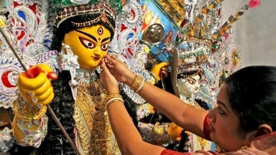 Day 2 – Saptami: It is believed that on this day the legendary battle between Goddess Durga and the demon king Mahishasura began. The rituals begin with the immersion of a banana tree in sacred water around the time of dawn. The tree is then draped with a saree and worshipped. This banana tree is recognised as Kala Bou and is depicted to be Ganesha’s wife. (PTI) Day 2 – Saptami: It is believed that on this day the legendary battle between Goddess Durga and the demon king Mahishasura began. The rituals begin with the immersion of a banana tree in sacred water around the time of dawn. The tree is then draped with a saree and worshipped. This banana tree is recognised as Kala Bou and is depicted to be Ganesha’s wife. (PTI)