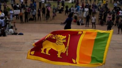 Sri Lanka Economic Crisis: A Sri Lankan flag is waved by a protester. (AP) Sri Lanka Economic Crisis: A Sri Lankan flag is waved by a protester. (AP)