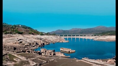 The abandoned village of Aceredo emerges, ghost-like, at the bottom of the Alto Lindoso reservoir in Spain. In the distance, a bridge spans waters that are now down to 15% of reservoir capacity. (Shutterstock) The abandoned village of Aceredo emerges, ghost-like, at the bottom of the Alto Lindoso reservoir in Spain. In the distance, a bridge spans waters that are now down to 15% of reservoir capacity. (Shutterstock)