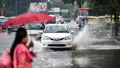 Vehicles drive though a waterlogged road in Delhi. (PTI) Vehicles drive though a waterlogged road in Delhi. (PTI)