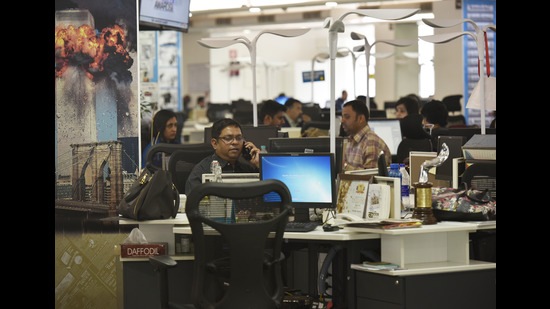 Journalists at work in a contemporary newsroom. (Raj K Raj/HT PHOTO)