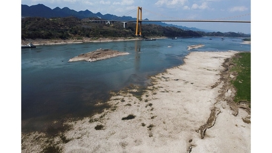 China is experiencing its most extreme heatwave in six decades. Rainfall along the basin of the Yangtze, the world’s third-largest river, has been 45% lower than usual. Lower parts of the basin are now in full view.(Thomas Peter/REUTERS)