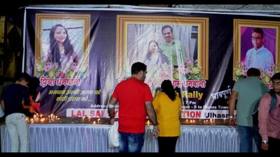 Residents light candles in front of the photos of the deceased on Friday following the slab collapse incident on Thursday that killed four persons. (PRAMOD TAMBE/HT PHOTO)