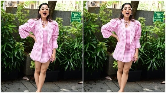 Rashmika, for the day promotions, picked a pink and white checkered short dress with halter neck details. She further teamed it with a blazer with the same print featuring dramatic puffy quarter sleeves.(HT Photos/Varinder Chawla)