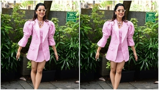 Rashmika wore her tresses into a messy knot and left her tresses open in straight locks as she smiled with all her hearts for the cameras.(HT Photos/Varinder Chawla)