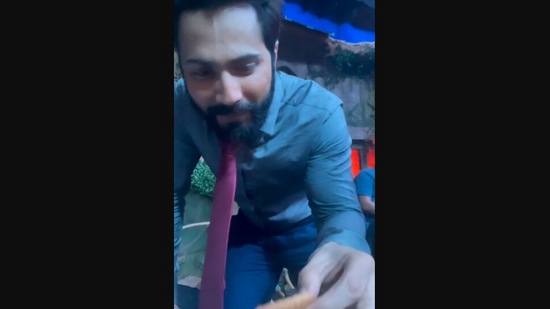 The image, taken from viral Instagram video, shows Varun Dhawan eating biscuit with chai.(Instagram/@varundvn)