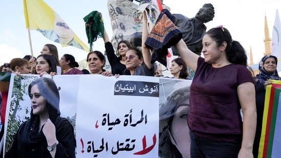 Kurdish women activists hold headscarfs and a portrait of Iranian woman Mahsa Amini, with Arabic that reads,.(AP) Kurdish women activists hold headscarfs and a portrait of Iranian woman Mahsa Amini, with Arabic that reads,.(AP)
