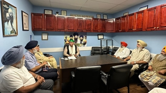 Fishing in troubled waters: Pakistani diplomat Janbaz Khan wearing green headband addresses Guru Nanak Gurdwara in Surrey with photographs of top Khalistani leaders behind him.