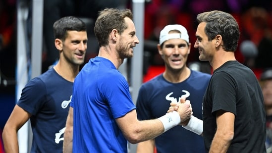 Andy Murray (L) shakes hands with Roger Federer next to Novak Djokovic (back L) and Rafael Nadal (back R) during a practice session