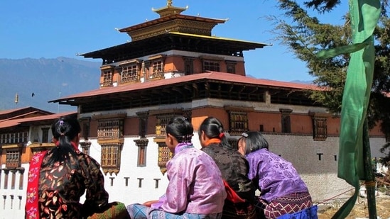 Bhutanese girls in traditional dress sit outside Rinpung Dzong in Paro Valley, Bhutan. (Representational image)(REUTERS)