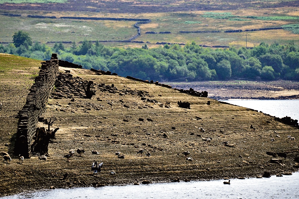The Thruscross reservoir, dried out in the heat wave, has revealed remnants of a 17th-century village that was submerged in the 1960s. (Getty Images) The Thruscross reservoir, dried out in the heat wave, has revealed remnants of a 17th-century village that was submerged in the 1960s. (Getty Images)