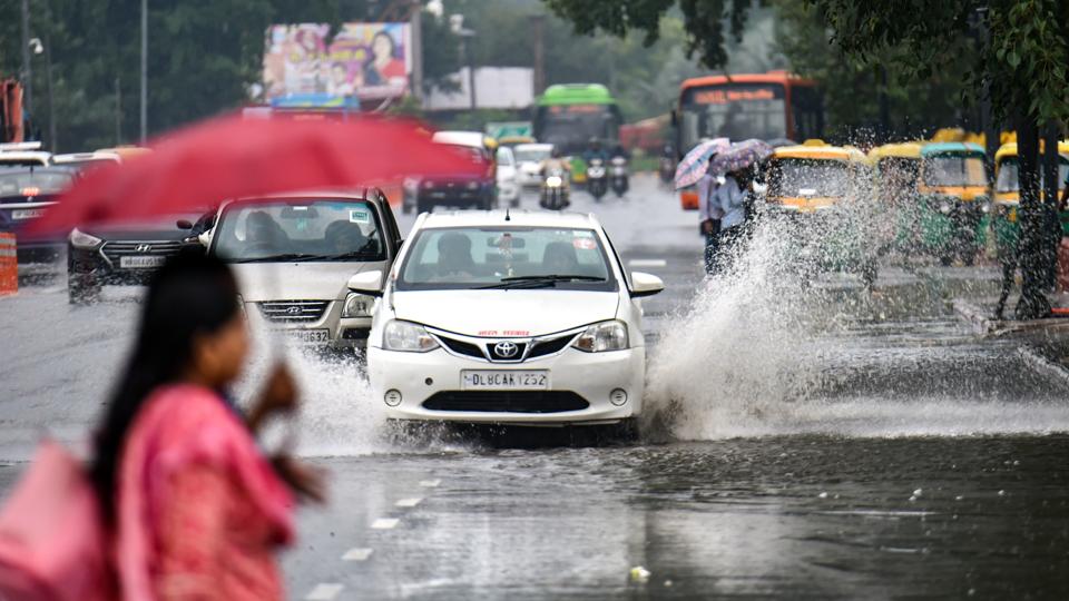 Vehicles drive though a waterlogged road in Delhi. (PTI photo) Vehicles drive though a waterlogged road in Delhi. (PTI photo)
