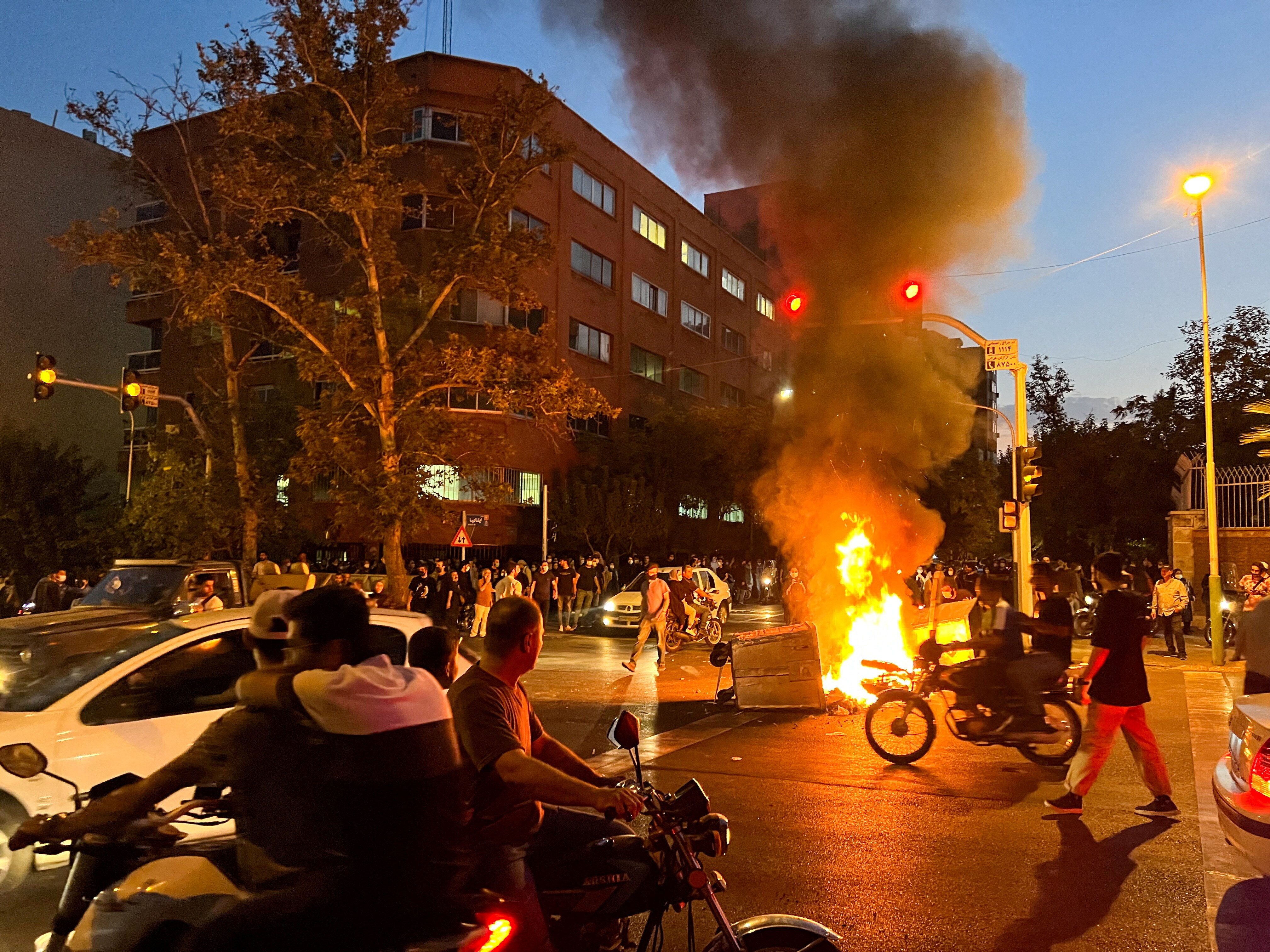 A police motorcycle burns during a protest over the death of Mahsa Amini, &nbsp;in Tehran, Iran. (Reuters Photo)